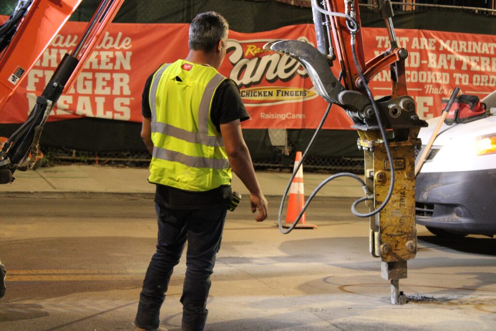 Trinity crew members in hi-vis directing breaker work at the Raising Cane's site