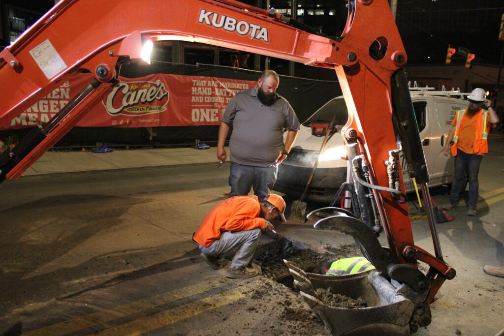 Crew making a utility tie-in on Broadway