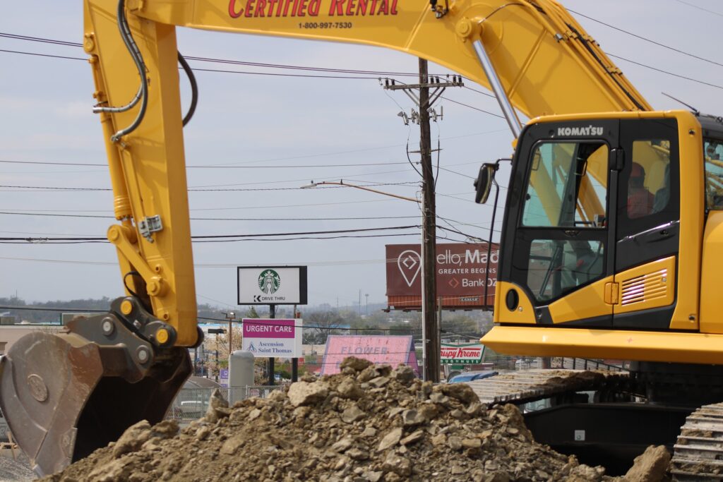 Excavator digging rock on Gallatin Pike