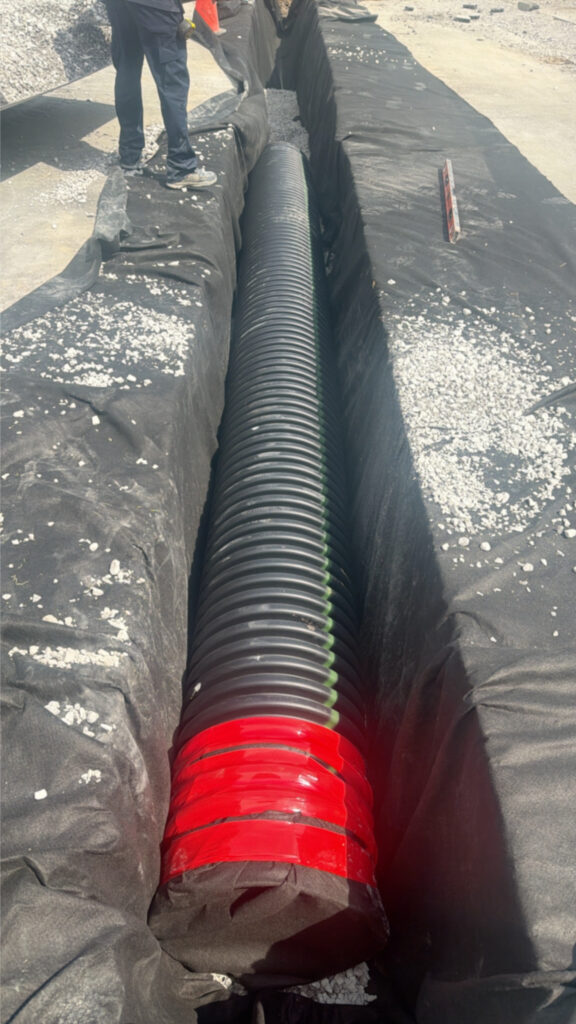 Corrugated pipe being installed in a trench at McDonald's Shelbyville