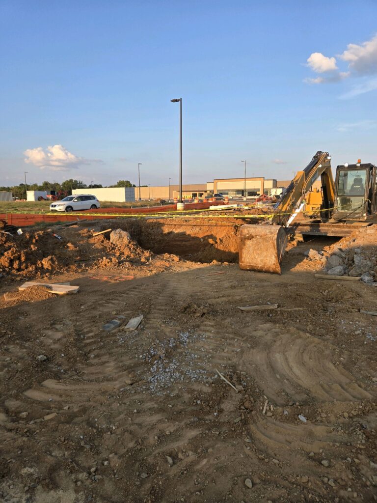Excavator grading the McDonald's site in Smyrna