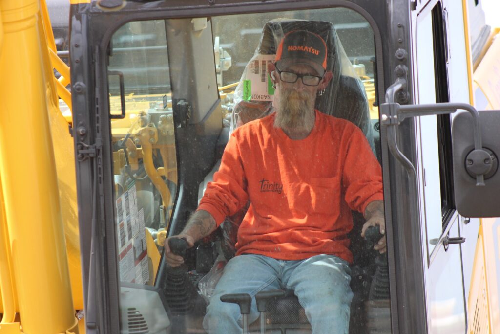 Trinity Earthworks equipment operator at the controls of an excavator