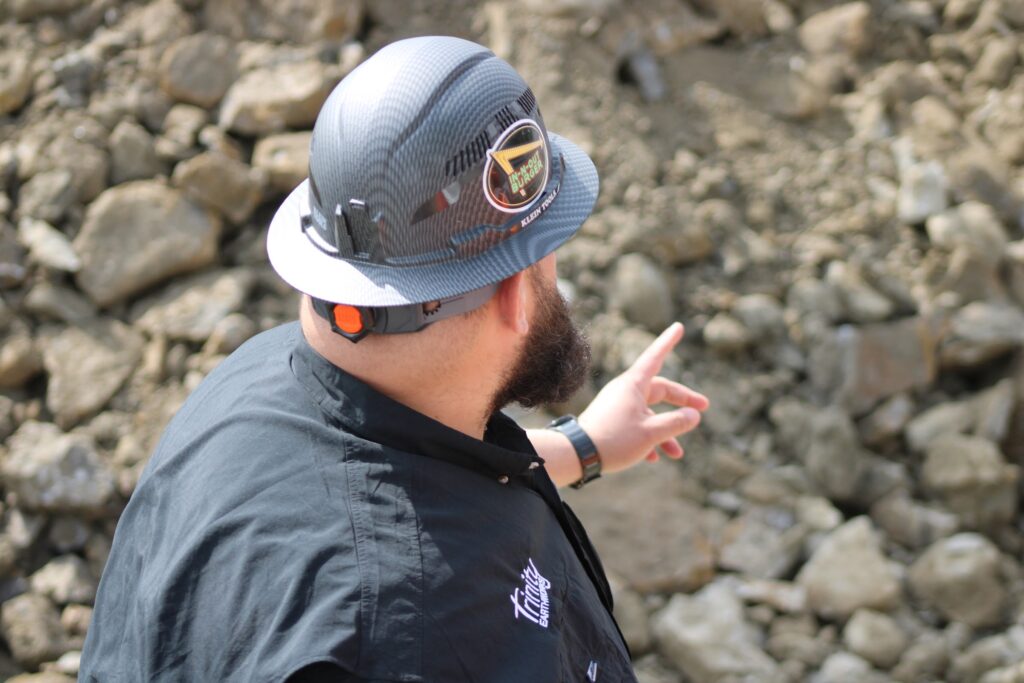 Trinity foreman in a hard hat directing excavation work